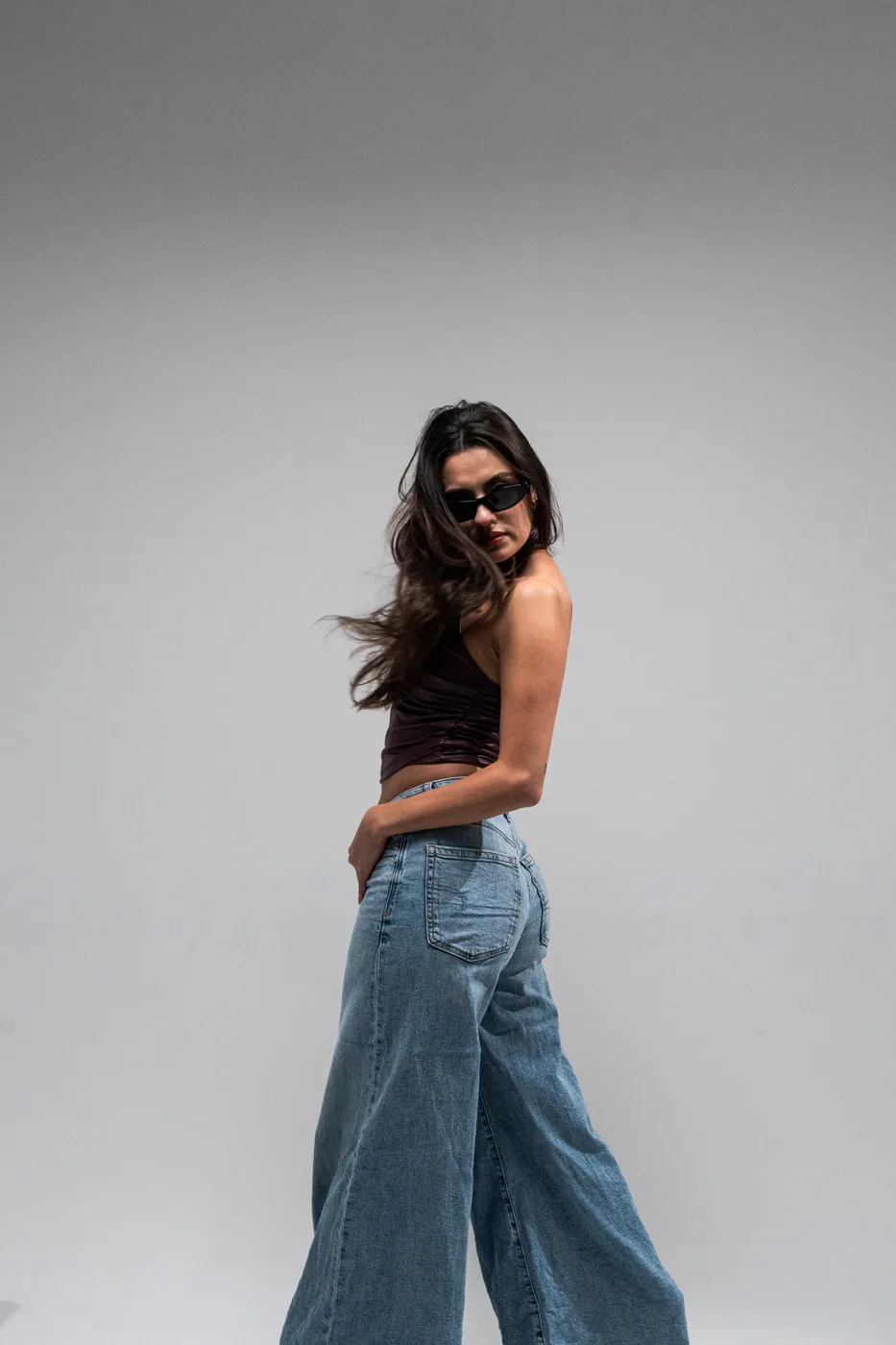 Profile with sunglasses, flared jeans